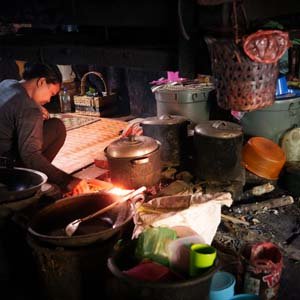 Jerry van de Beek - Woman Cooking inside a Batak House in Indonesia